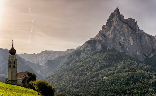 istock Church on the meadow and mountains in the background 845905248
