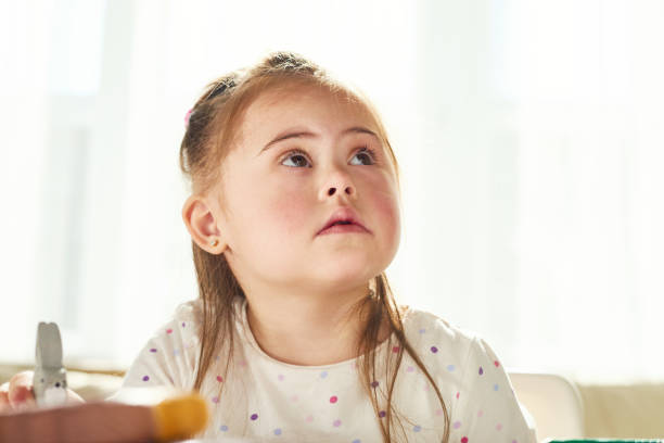 Pensive little girl with genetic illness
