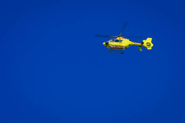 istock Yellow helicopter on clear dark blue sky 845905482