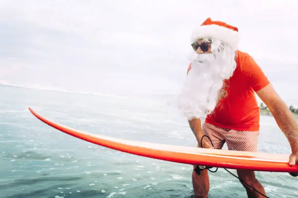 Photo of Santa Claus with surf board