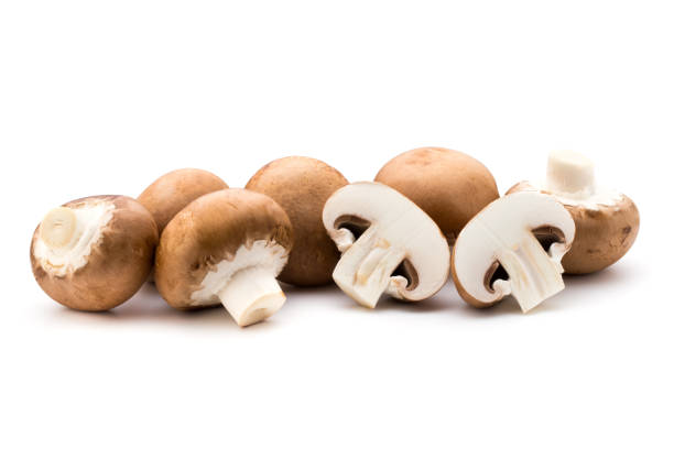 istock Fresh champignon mushrooms isolated on white. 845905846