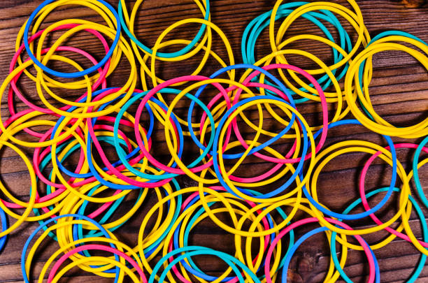 istock Multicolored rubber bands on wooden table. Top view 845910120