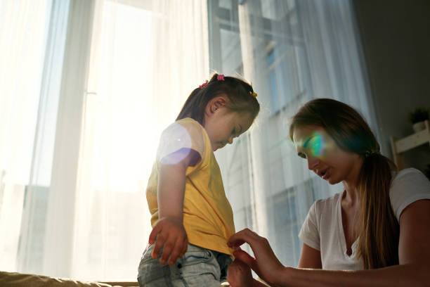 Mother calms her crying daughter