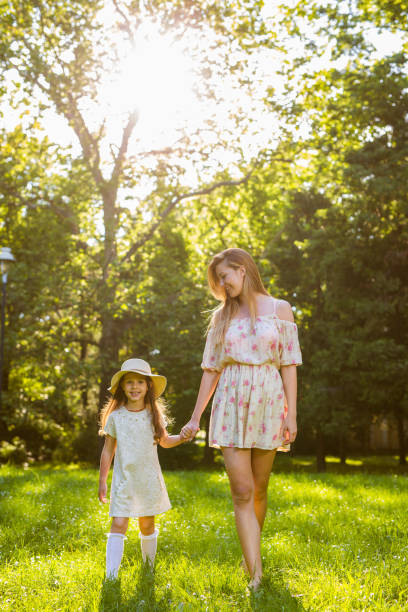 istock Mother and daughter taking a walk in the park 845910472