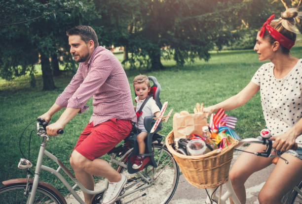 istock Young family riding bicycles in the park 845911552