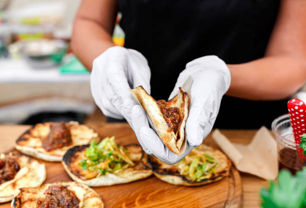 istock Street vendor hands making taco outdoors 845911984