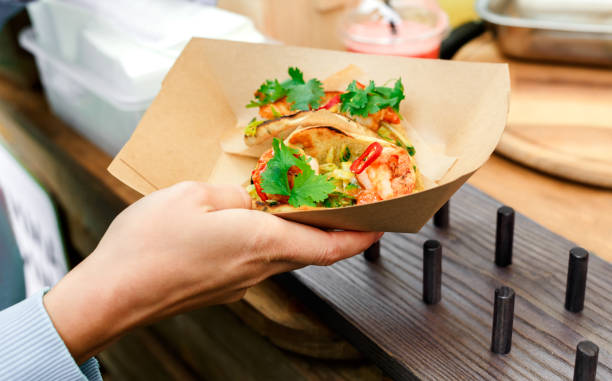 istock Street vendor hands making taco outdoors 845912082