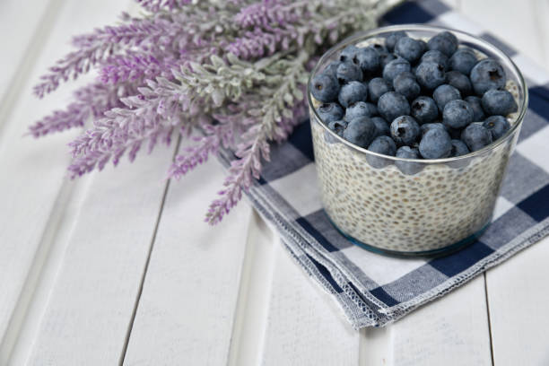 istock Chia pudding with blueberries on striped canvas, white wood background 845915472