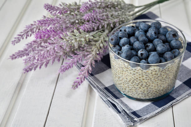 istock Chia pudding with blueberries on striped canvas, white wood background 845915530