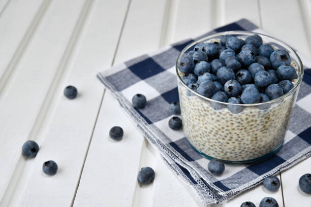 istock Chia pudding with blueberries on striped canvas, white wood background 845915626