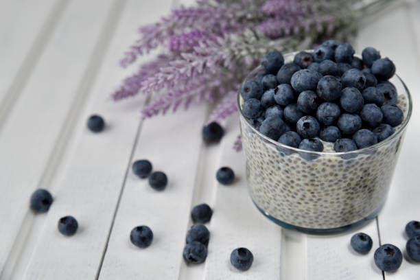 istock Chia pudding with blueberries on striped canvas, white wood background 845915830