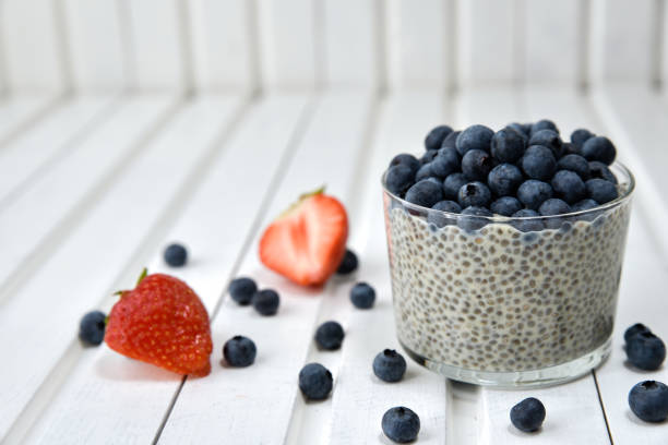 istock Chia pudding with blueberries on striped canvas, white wood background 845915922