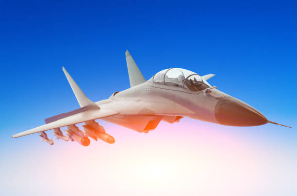 istock Military fighter against a blue sky with a backlight from below 845915960