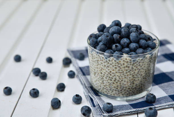 istock Chia pudding with blueberries on striped canvas, white wood background 845916004