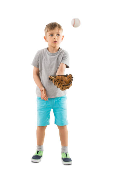 boy trying to catch baseball in his glove - baseball baseballs catching baseball glove imagens e fotografias de stock