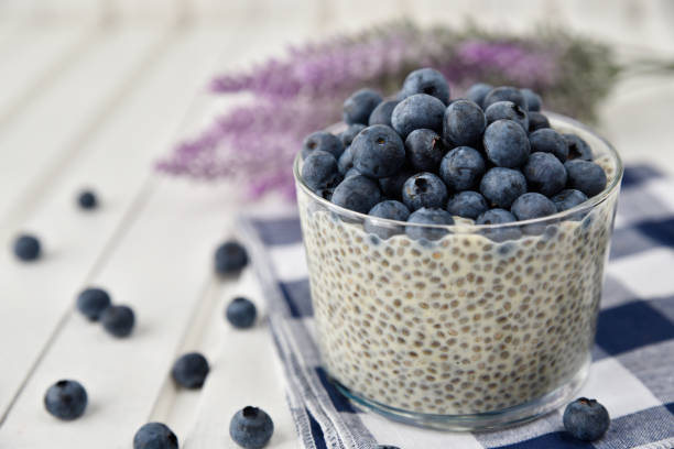 istock Chia pudding with blueberries on striped canvas, white wood background 845916120