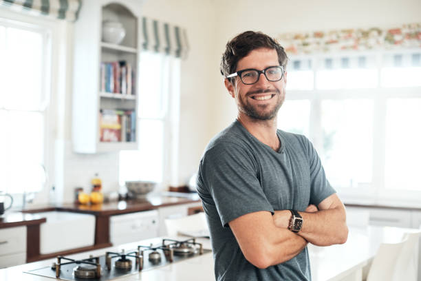 Confidence - practice it daily Portrait of a confident and happy young man at home bachelor stock pictures, royalty-free photos & images