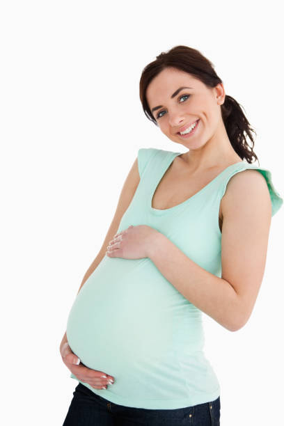 istock Young pregnant woman smiling at camera 845922408