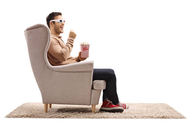 istock Young man wearing a pair of 3D glasses and having popcorn 845927088