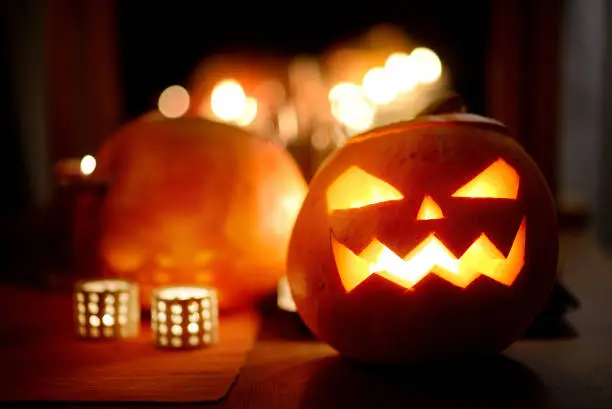 Group of spooky Halloween jack-o-lanterns lit at night