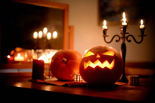 Group of spooky Halloween jack-o-lanterns lit at night