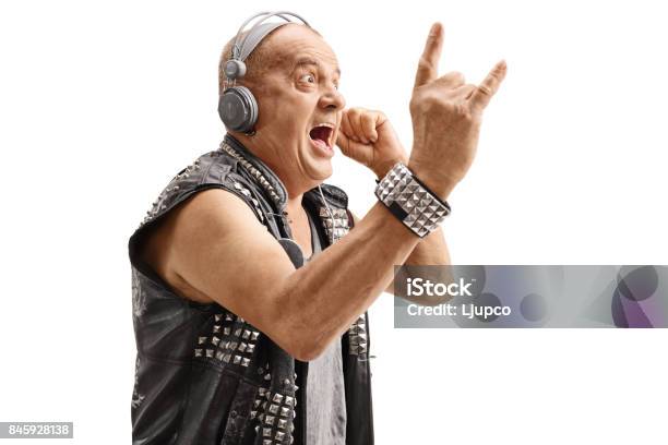 Elderly Punker Listening To Music And Making Rock Hand Gesture Stock Photo - Download Image Now