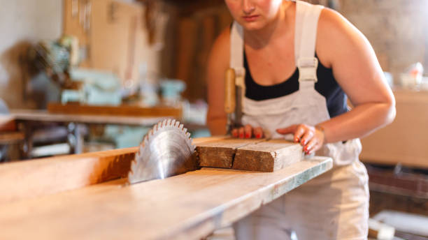 Carpenters sawing Carpenter cuts wood with circular saw 
 fähigkeit stock pictures, royalty-free photos & images