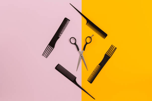 istock Barber set with combs and scissors on pink and yellow background 845930486