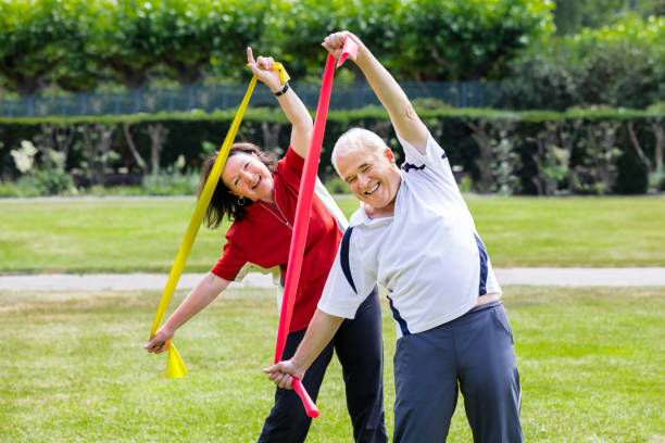 istock Senior Couple Exercising With Yoga Belt 845931032