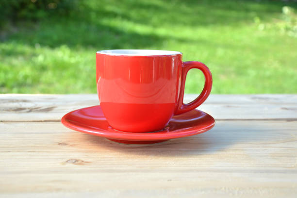 istock Coffee in red cup in garden 845931092