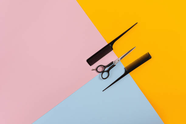 istock Barber set with two combs and scissors on the color pink, yellow, blue paper background 845931262