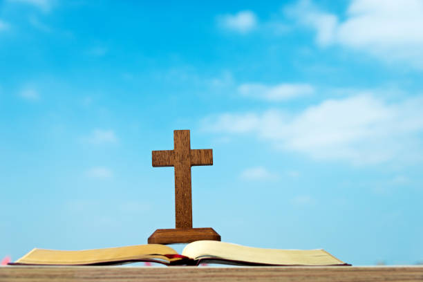 istock Bible and cross under the blue sky 845931424
