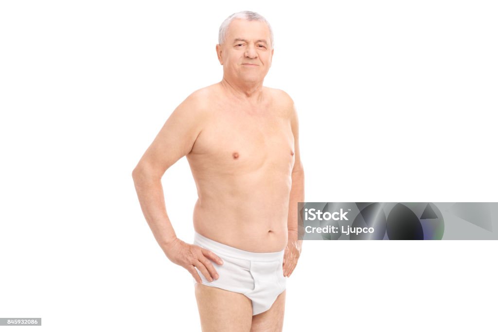 Mature man in underwear looking at the camera Mature man in underwear looking at the camera isolated on white background Naked Stock Photo