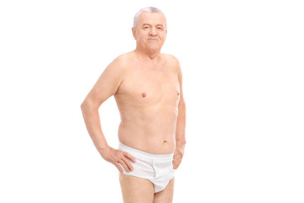 Mature man in underwear looking at the camera Mature man in underwear looking at the camera isolated on white background naked stock pictures, royalty-free photos & images