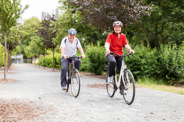 istock Smiling Senior Couple Cycling In Park 845932710