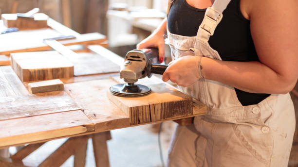 Carpenter grinding Carpenter grinds a piece of wood smooth - 
 ingenieur stock pictures, royalty-free photos & images