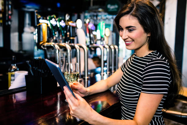 istock Woman using tablet and having a glass of wine 845932880