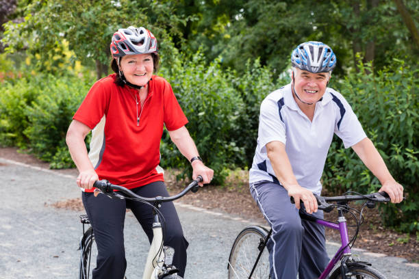 istock Smiling Senior Couple Cycling In Park 845933172