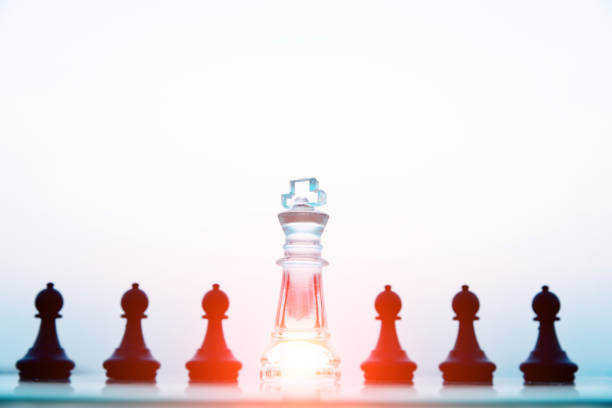 istock Transparent king and black pawns 845935528