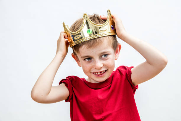 istock happy beautiful child with a wiggled tooth wearing a crown 845936022
