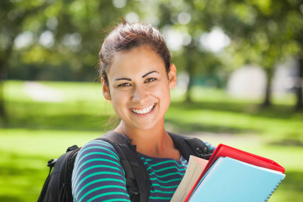 istock Casual cheerful student holding books 845936068