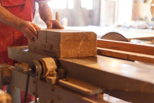 Carpenter at work Male carpenter cuts piece of wood fähigkeit stock pictures, royalty-free photos & images