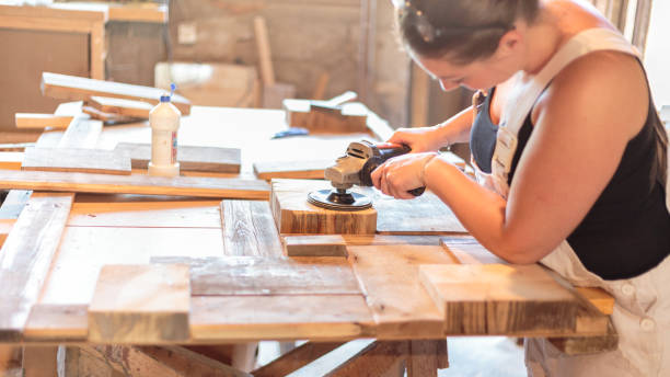 Carpenters grinding Carpenter grinds a piece of wood smooth - 
 ingenieur stock pictures, royalty-free photos & images