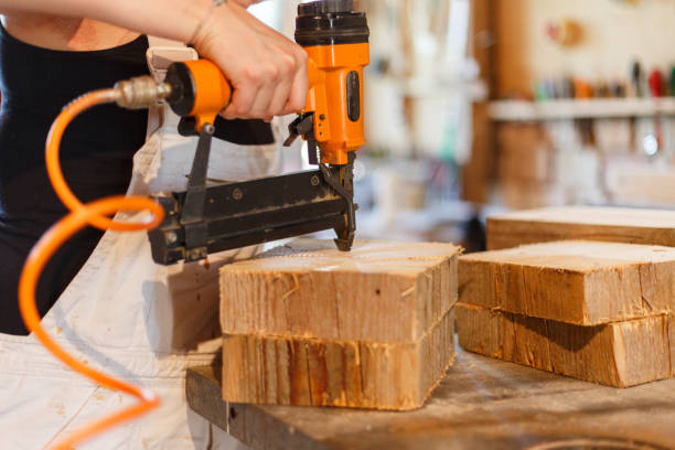 carpenter Carpenter with nail gun - 
 fähigkeit stock pictures, royalty-free photos & images