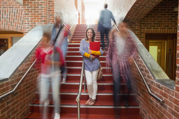 istock Casual smiling student standing on stairs 845939310