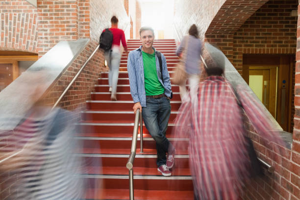 istock Casual handsome student standing on stairs 845939324