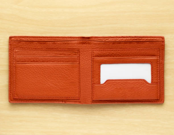 orange leather wallet orange leather wallet on wooden board background wallet photos stock pictures, royalty-free photos & images