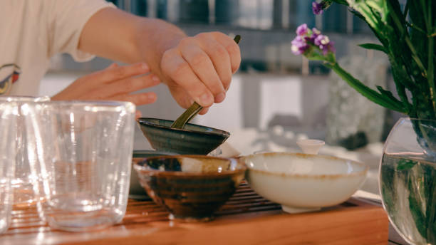 istock Tea ceremony on a shepherd with Buddha figures close-up. Conducting a traditional tea ceremony with Chinese tea 845942600