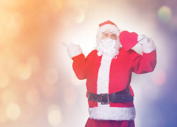 istock Santa Claus holding heart shape gift 845946312