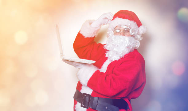 istock Funny Santa Claus have a fun with laptop 845946366